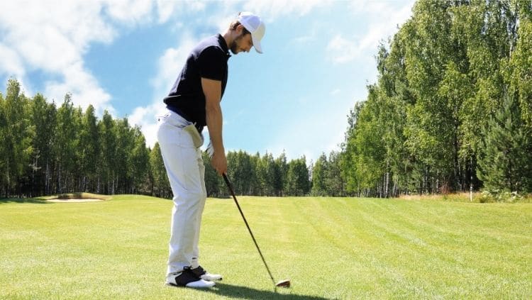 male golf player playing golf on sunny day
