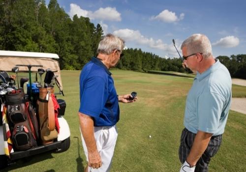 Golfers checking GPS rangefinder