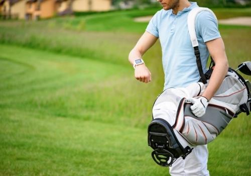 golfer checking time on smartwatch