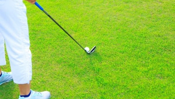 golfer taking a shot with iron