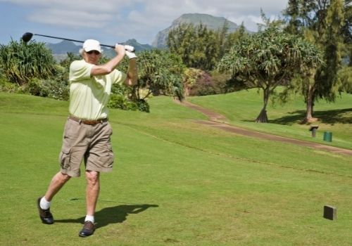 senior golfer swinging club