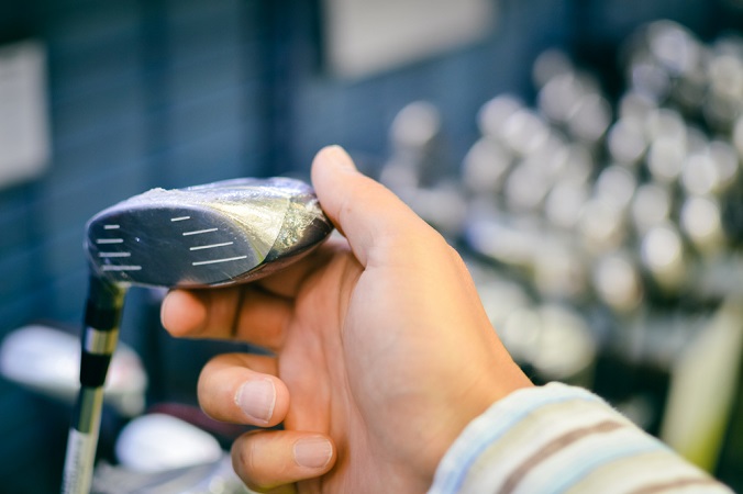 hand holding fairway wood